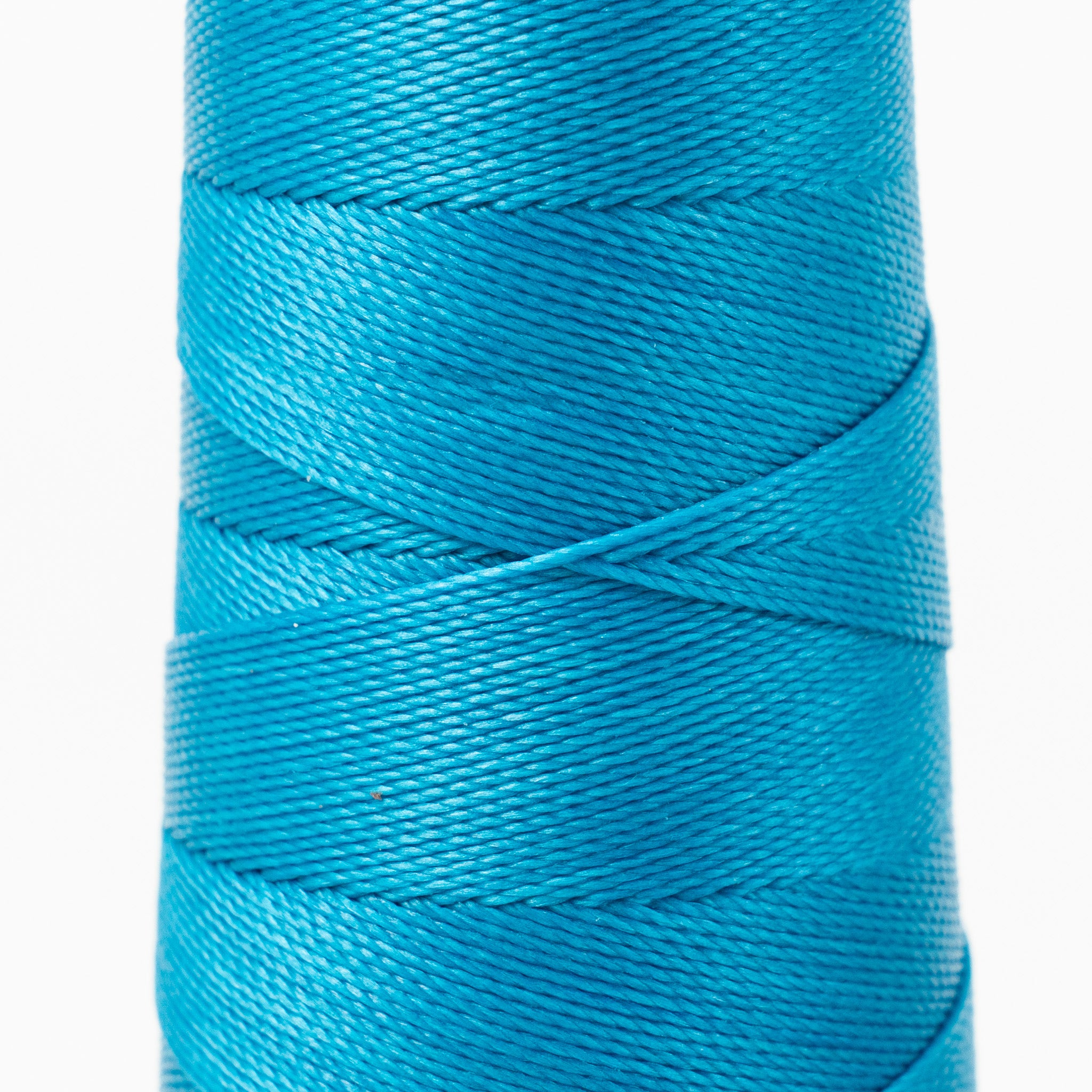 Close-up of MBT cyan waxed polyester thread