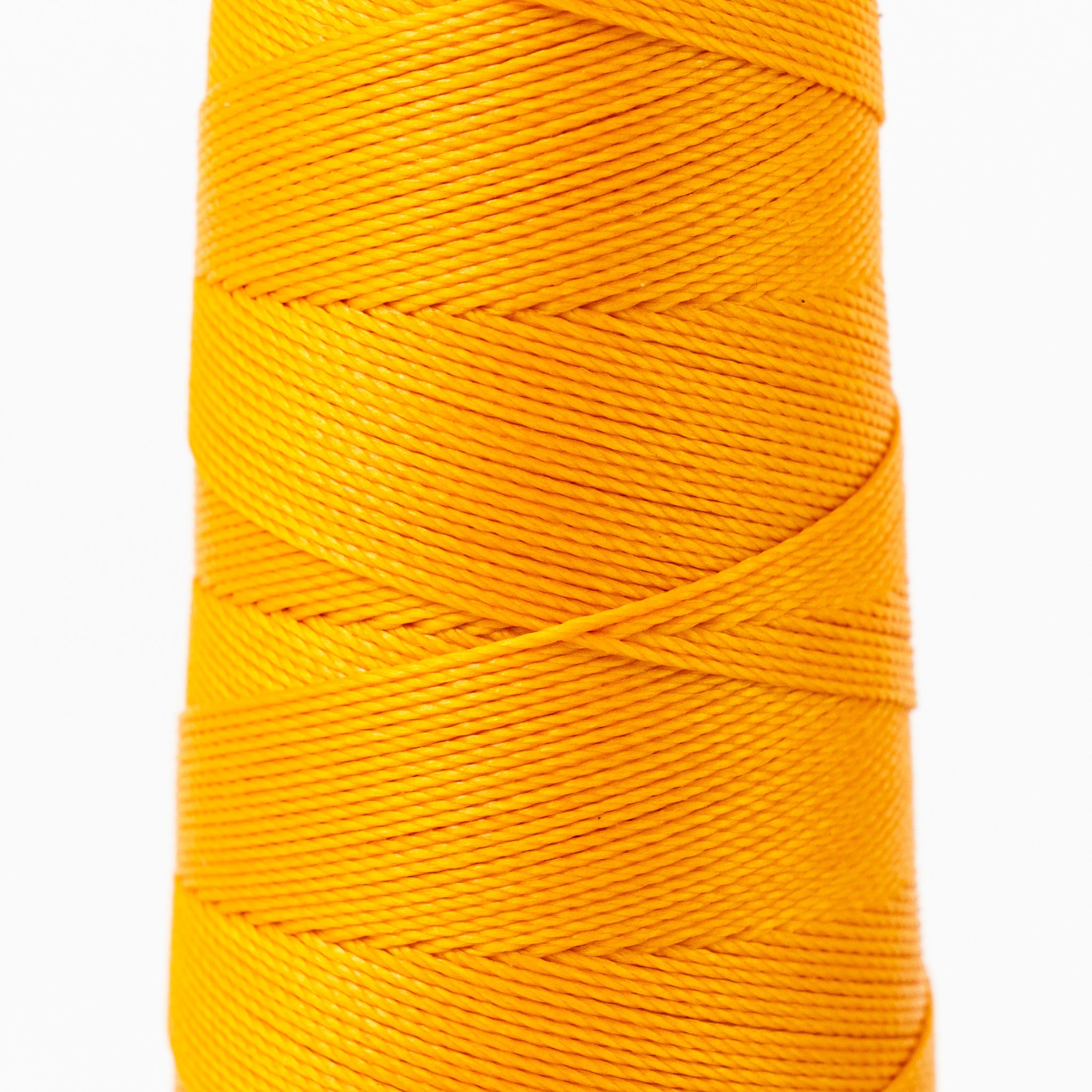 Close-up of MBT deep saffron waxed polyester thread