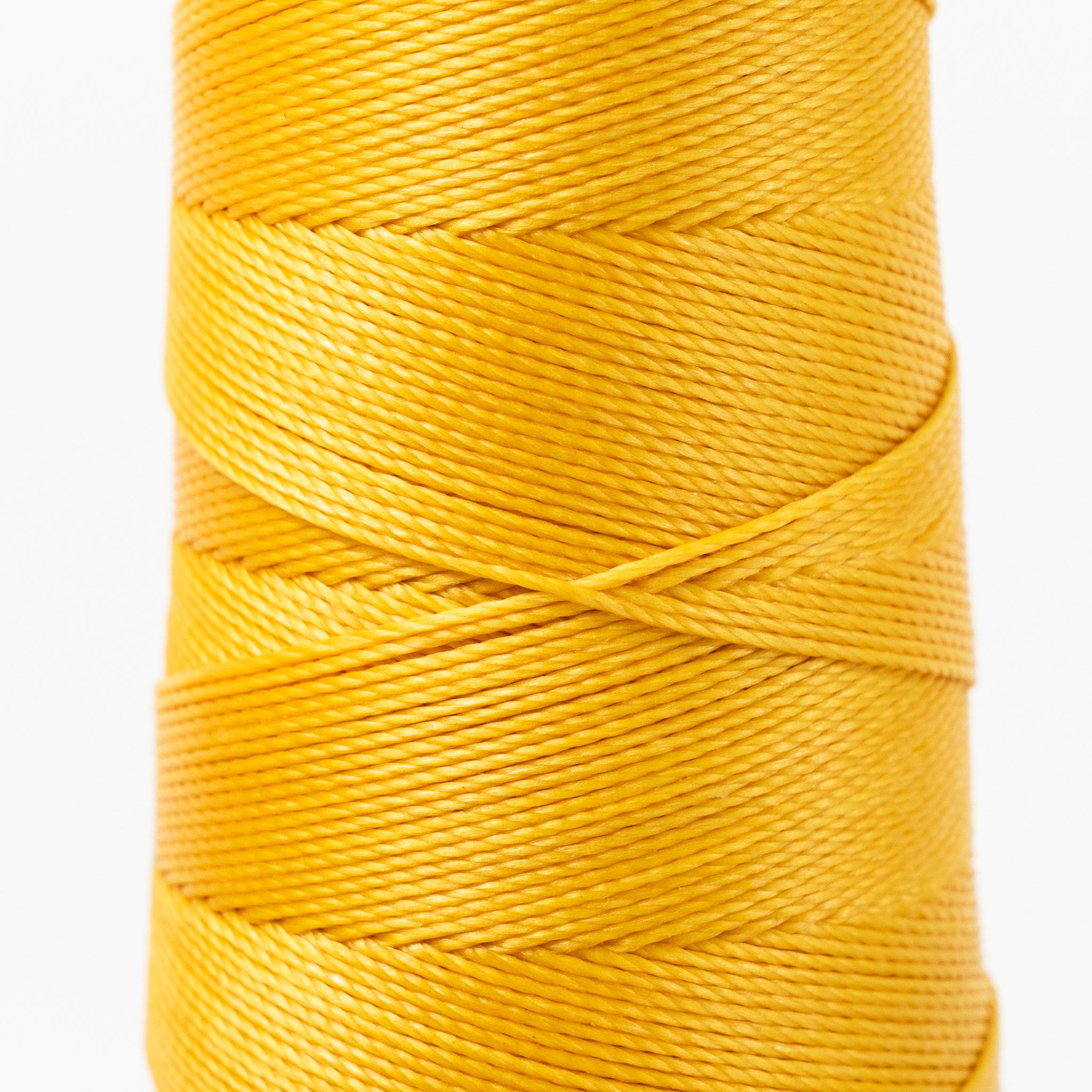 Close-up of MBT yellow and orange waxed polyester thread