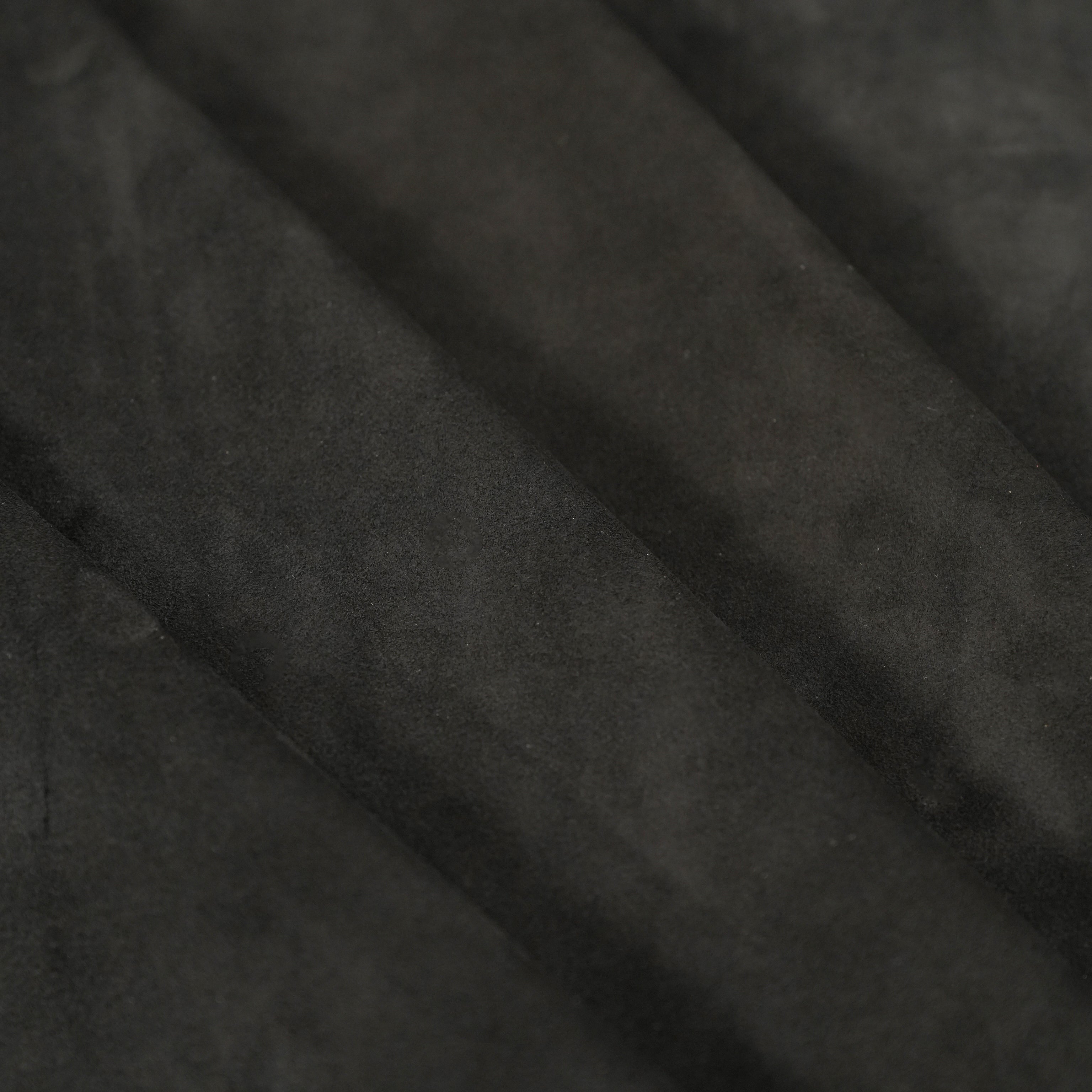 suede back side of black cowhide leather close-up