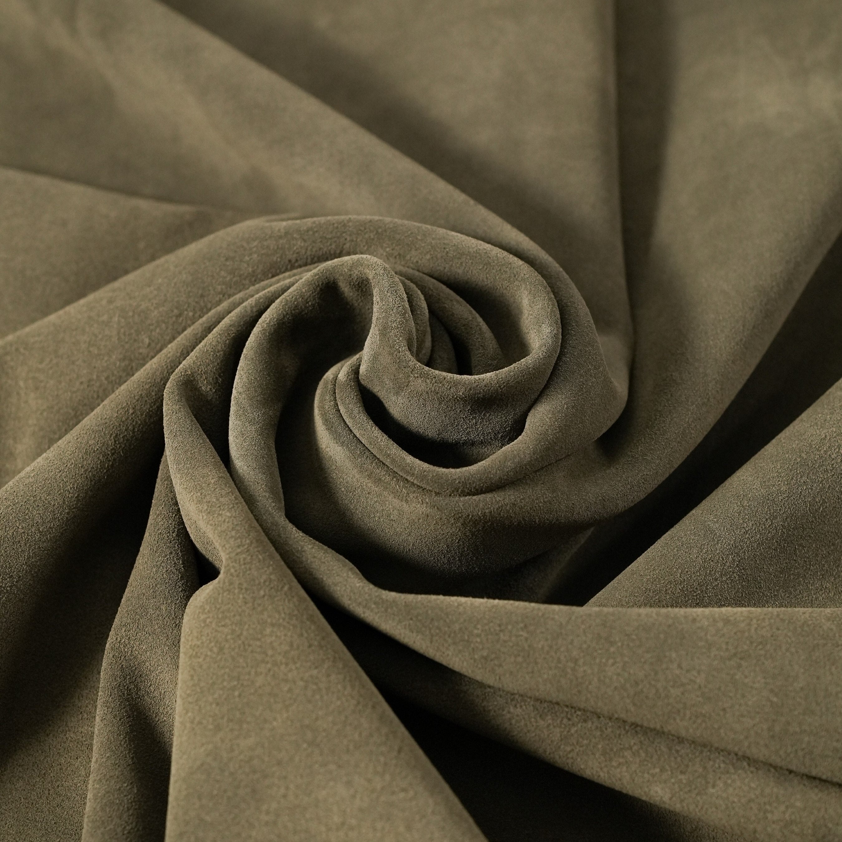 cowhide suede leather khaki green close-up flat lay texture