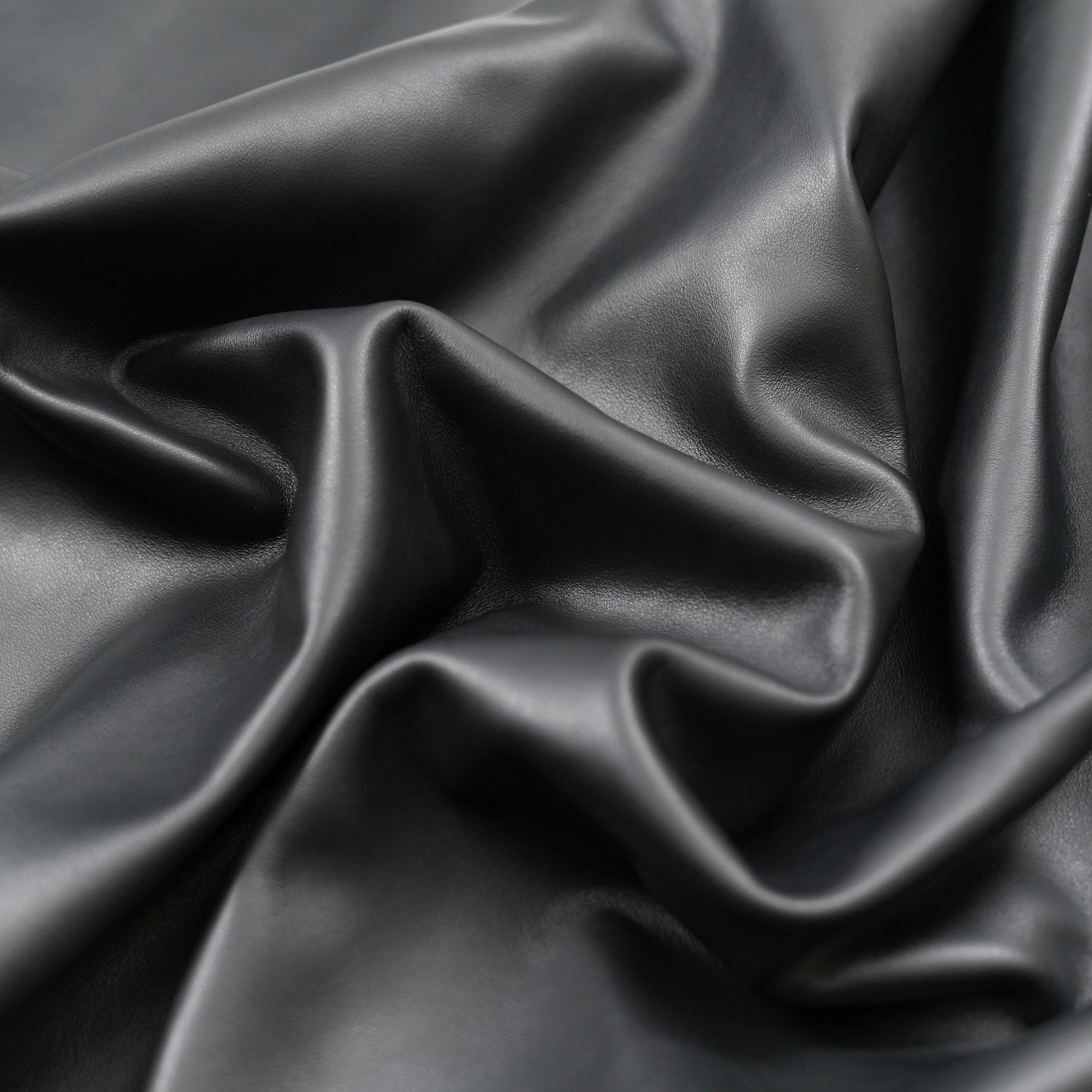 Black color nappa calfskin leather close-up soft folds