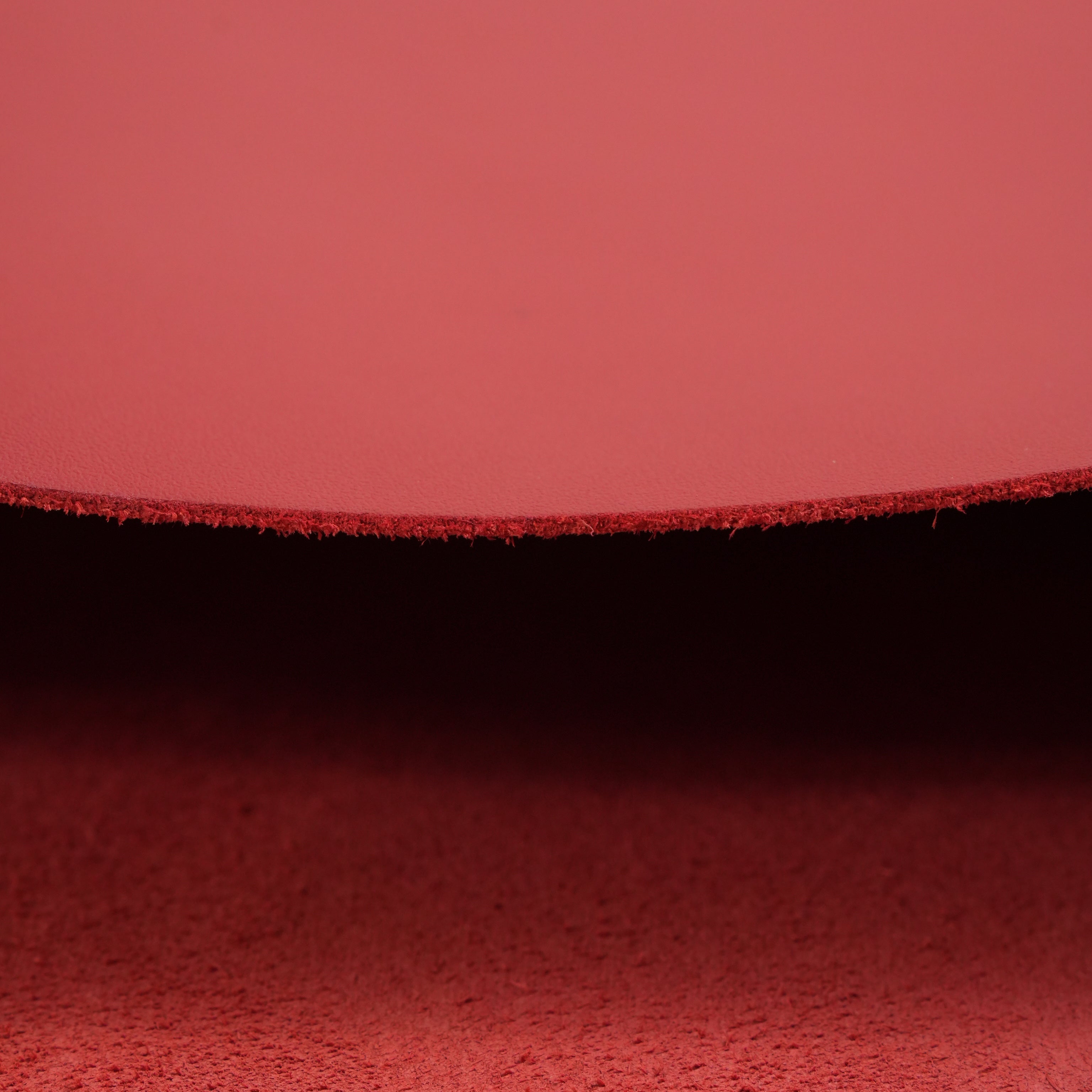 red top-grain premium italian leather edge close-up view
