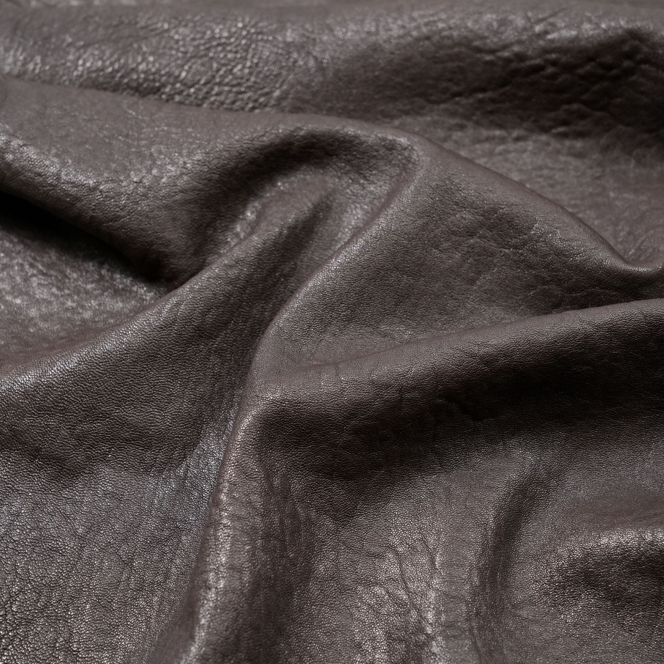 veg tan lambskin leather washed close up view dark brown