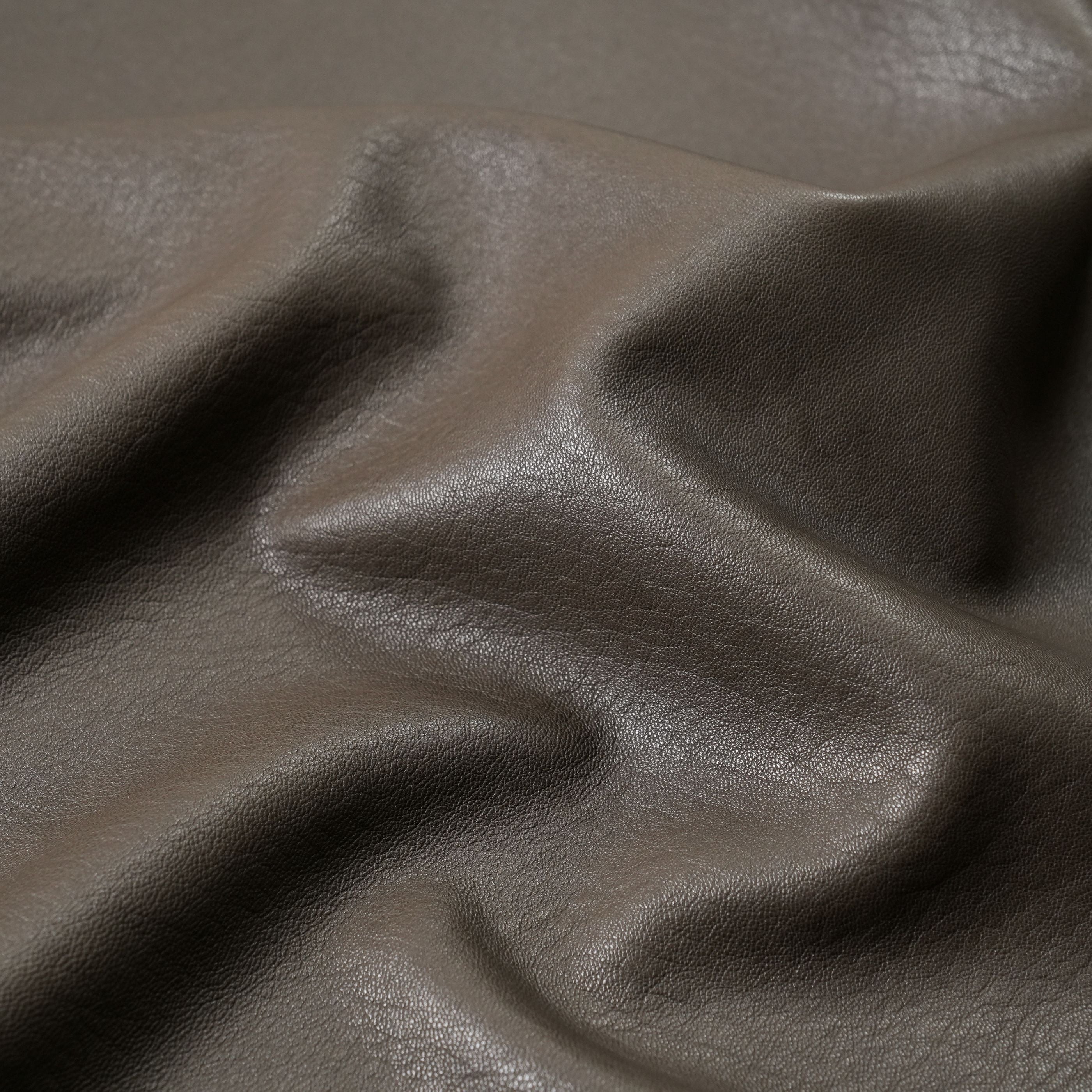 veg tan lambskin leather washed close up view khaki green