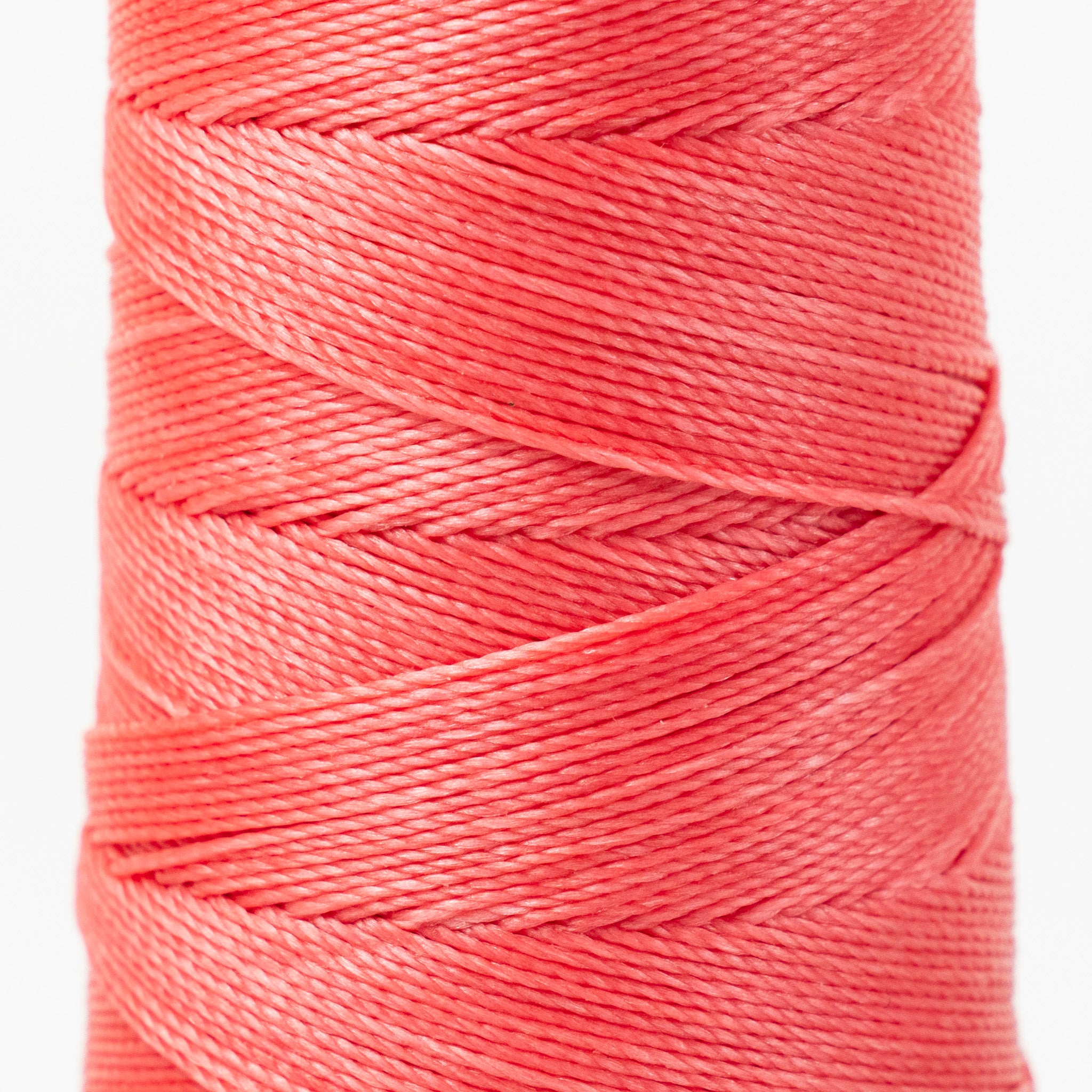 Close-up of MBT coral pink waxed polyester thread