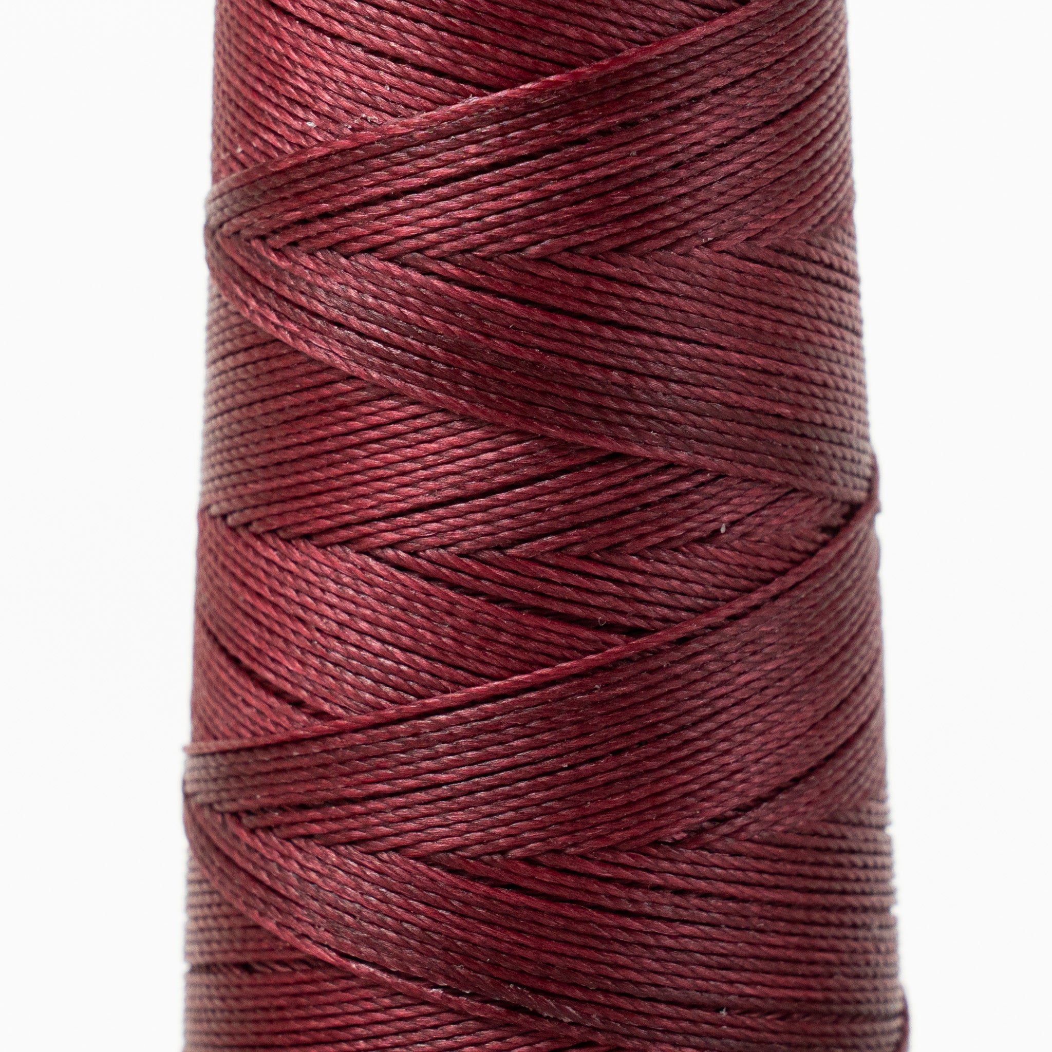 Close-up of MBT tyrian purple waxed polyester thread
