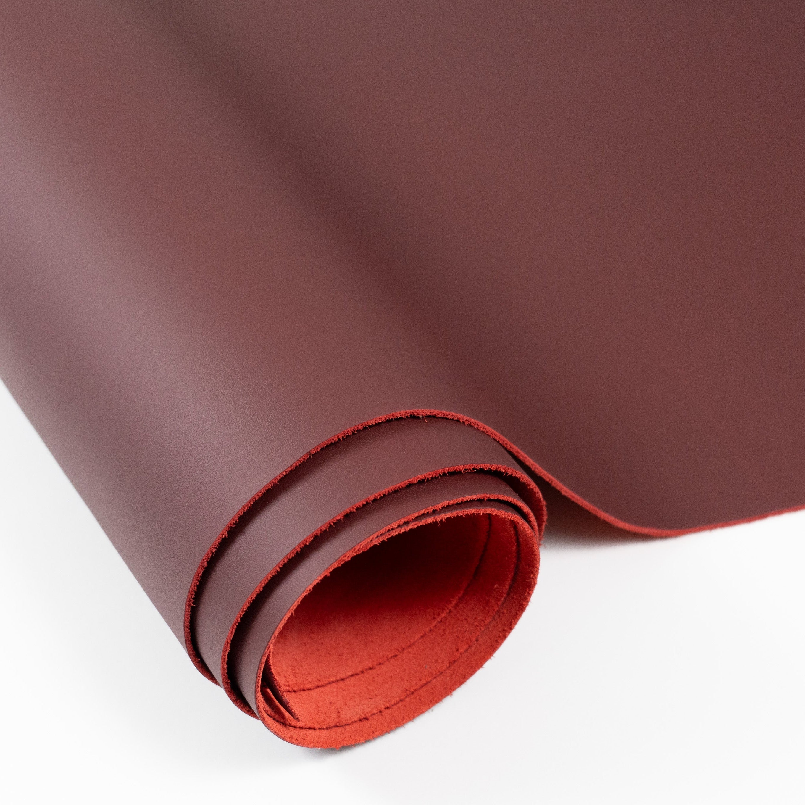 burgundy top grain premium italian leather with red backside partially unrolled view
