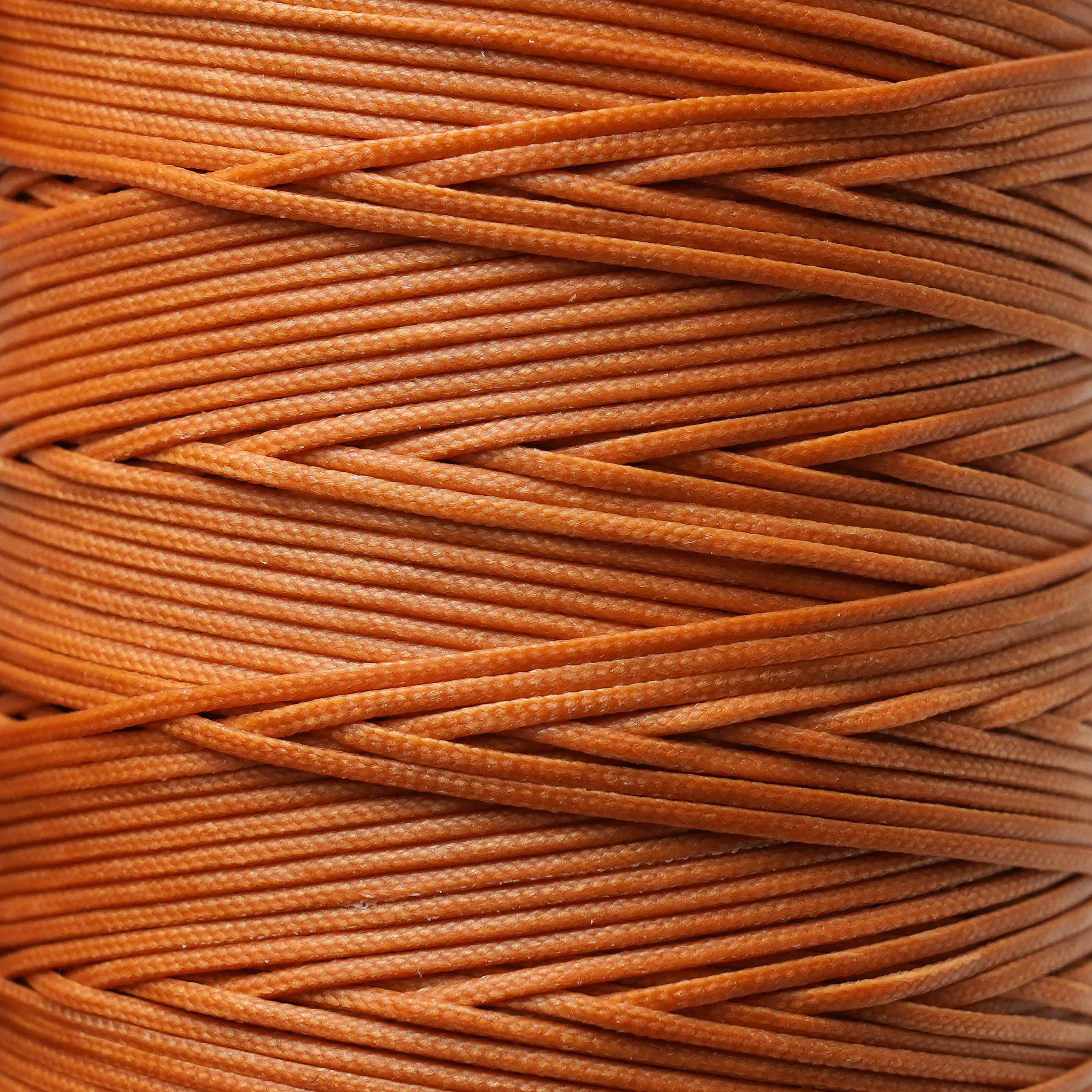 maine thread braided waxed cord spool burnt orange close up view