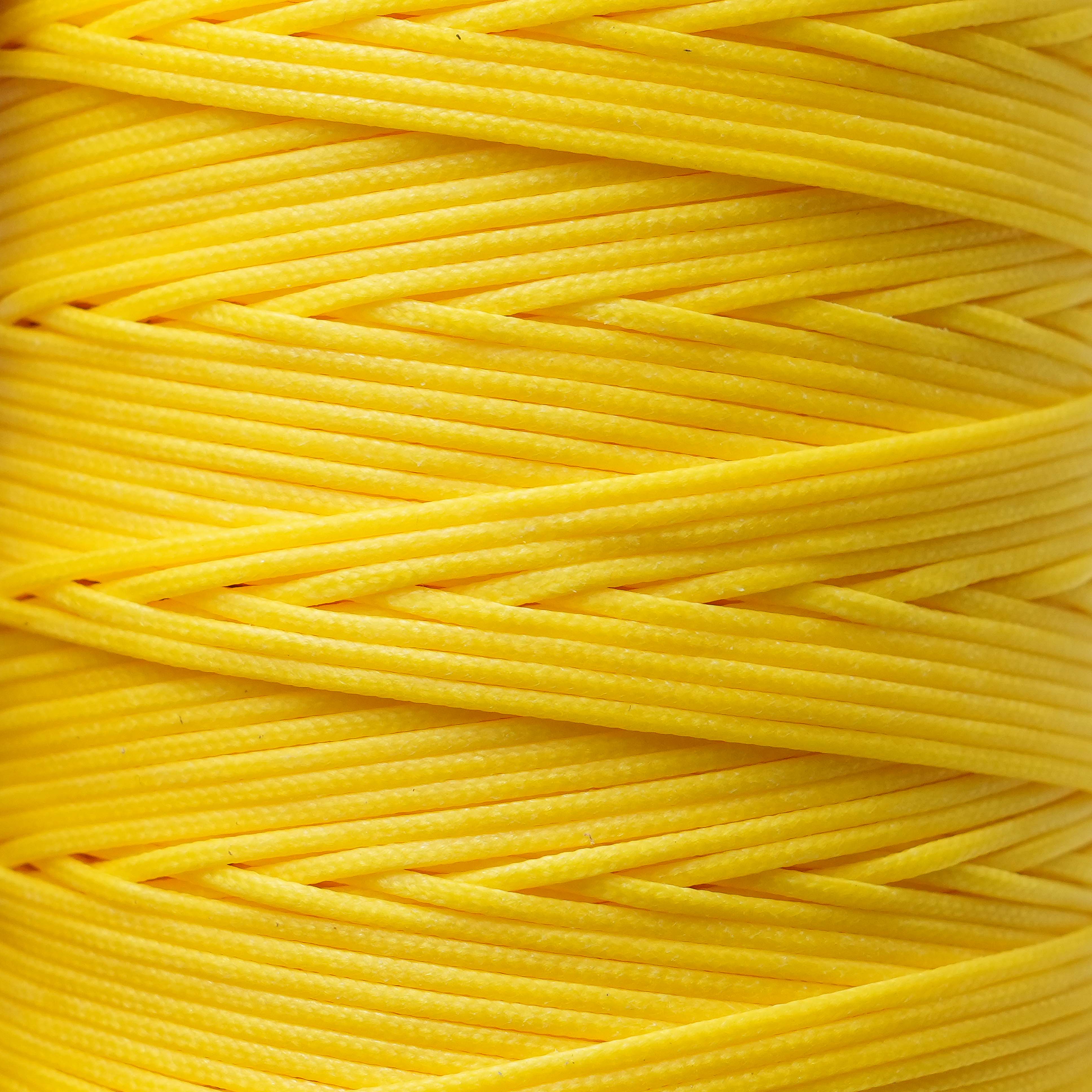 Close-up of a spool of canary yellow thread