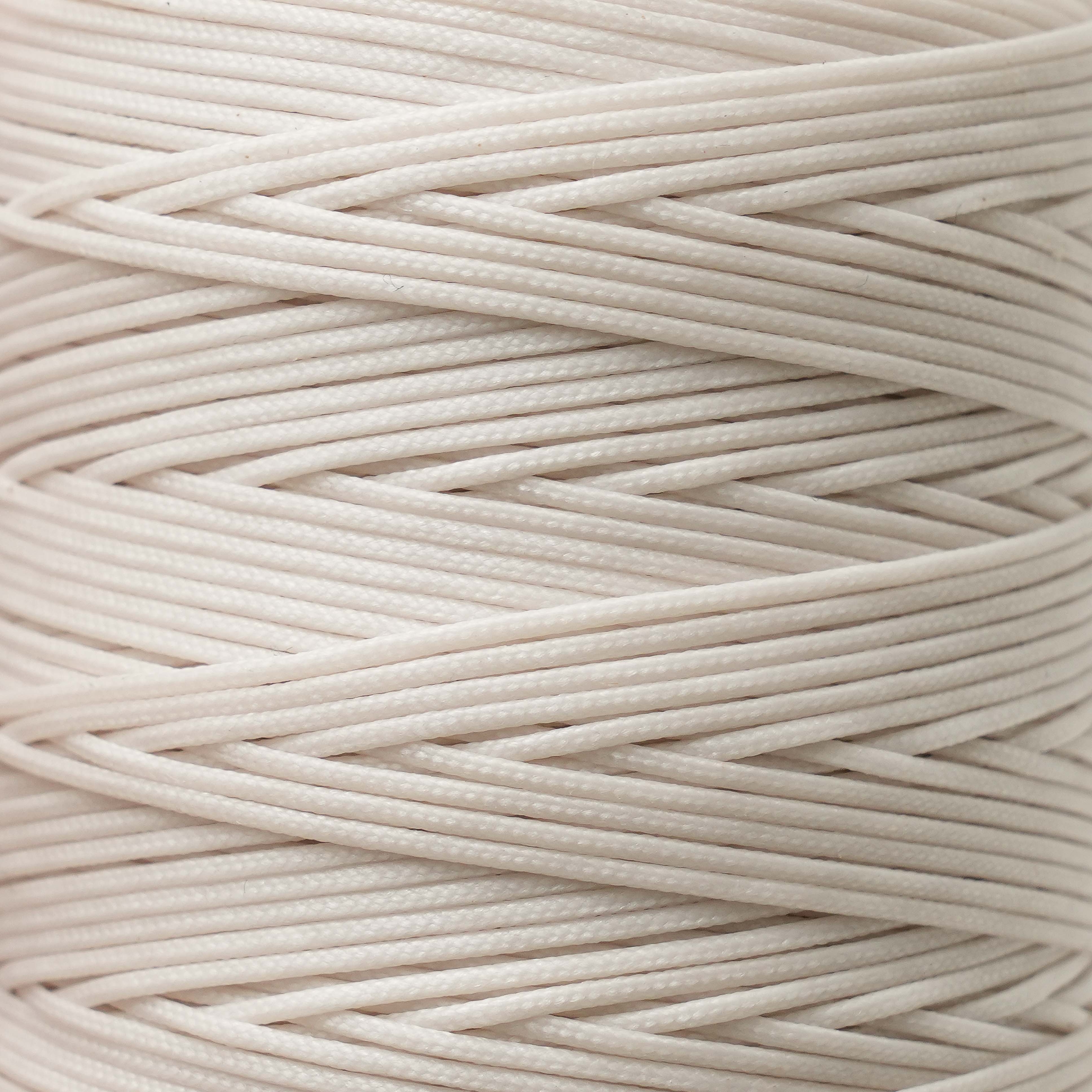 Close-up of ivory thread spool