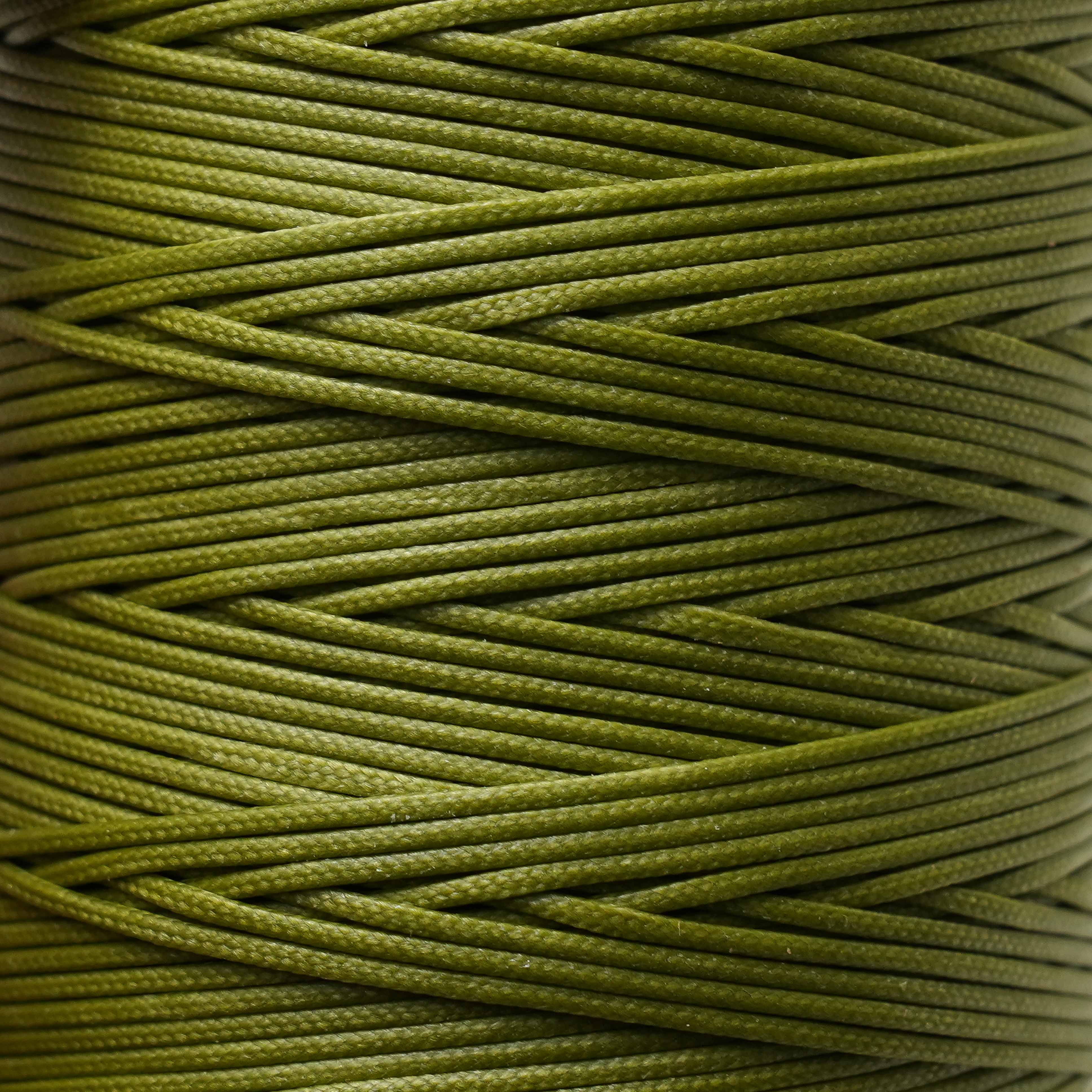 Close-up of a spool of olive green thread