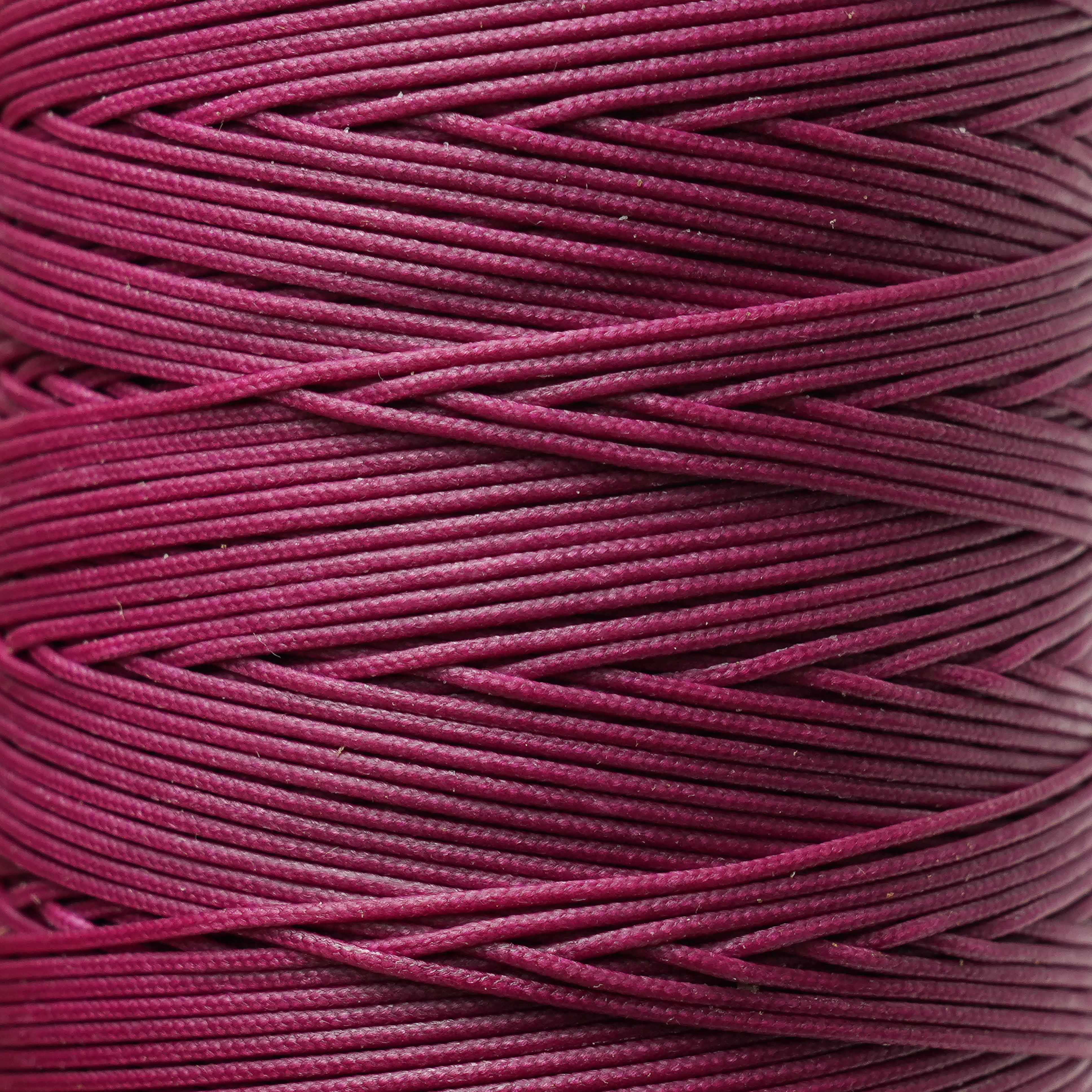 Close-up of a spool of plum thread