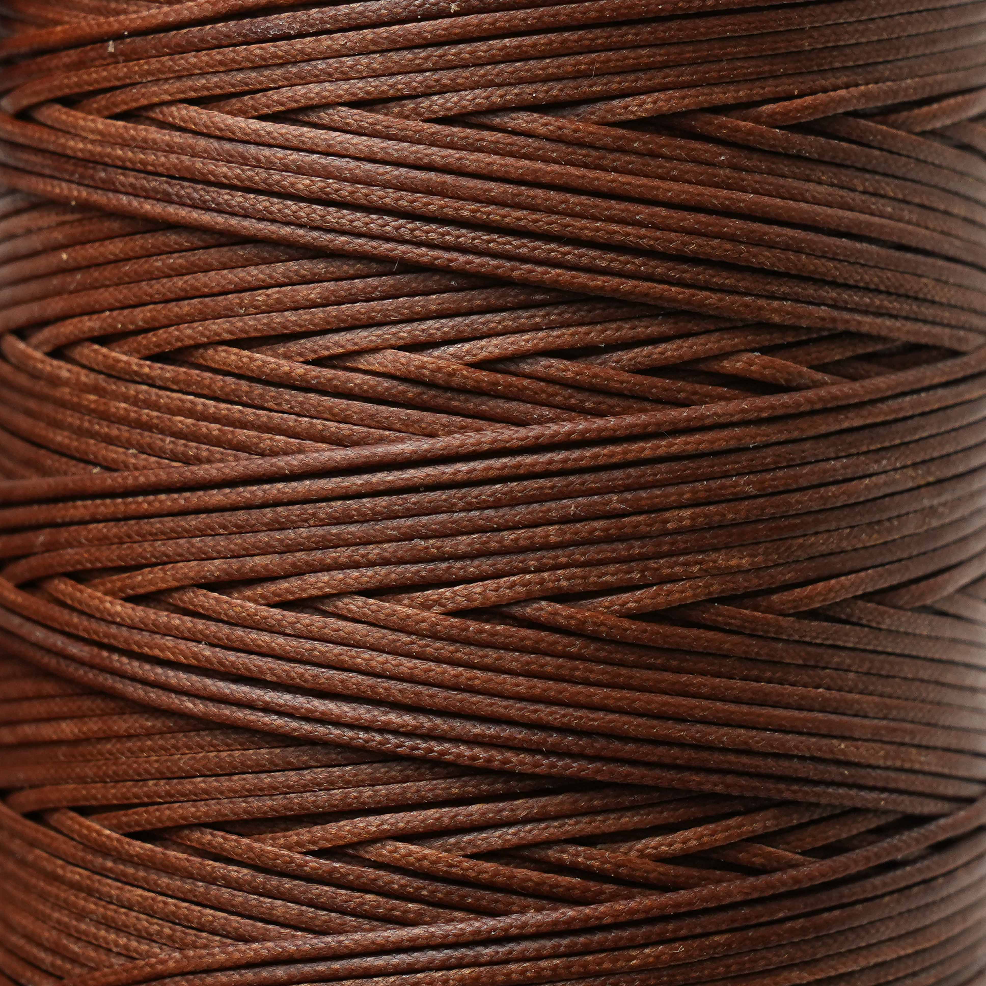 Close-up of a spool of russet thread