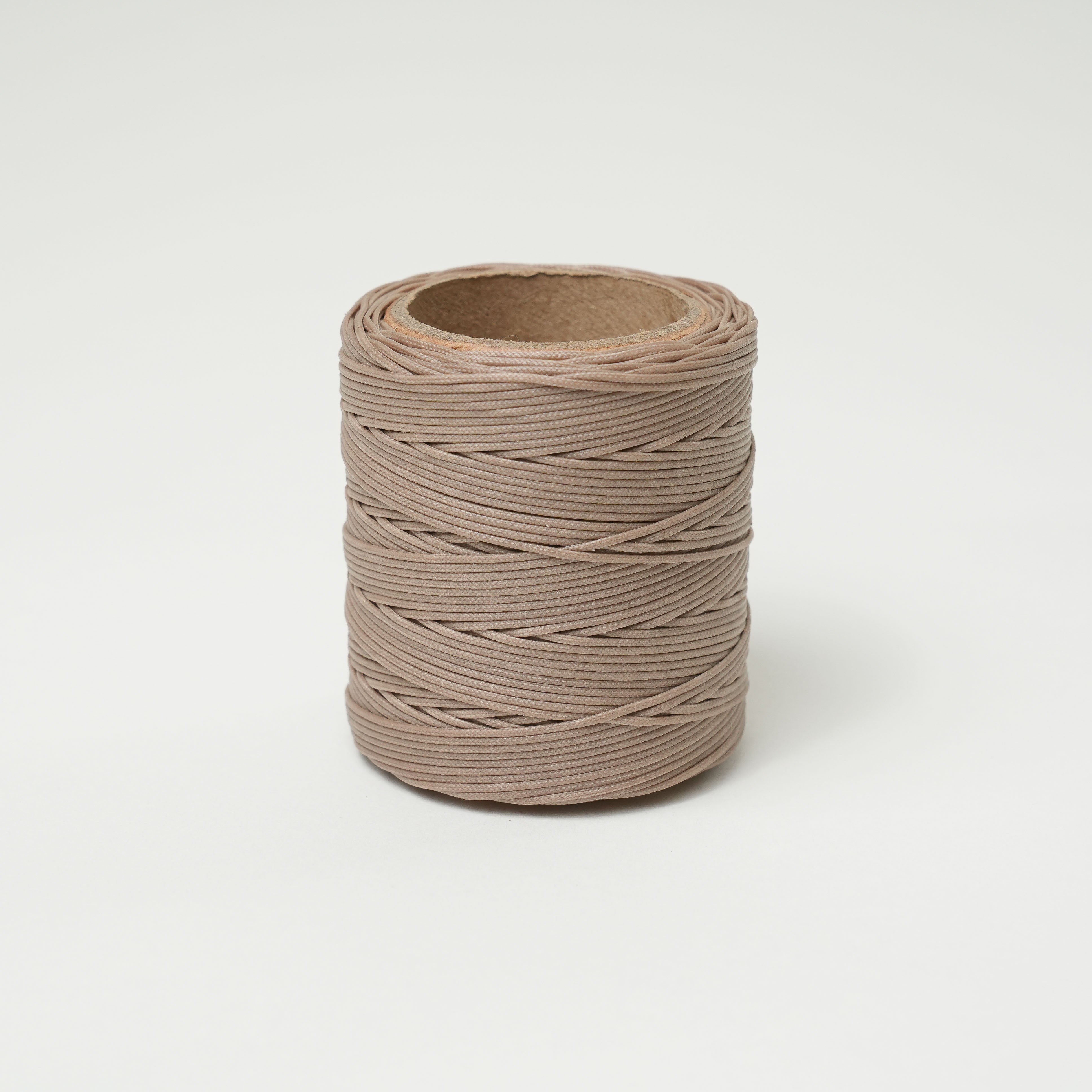 Roll of sandstone thread on a white background