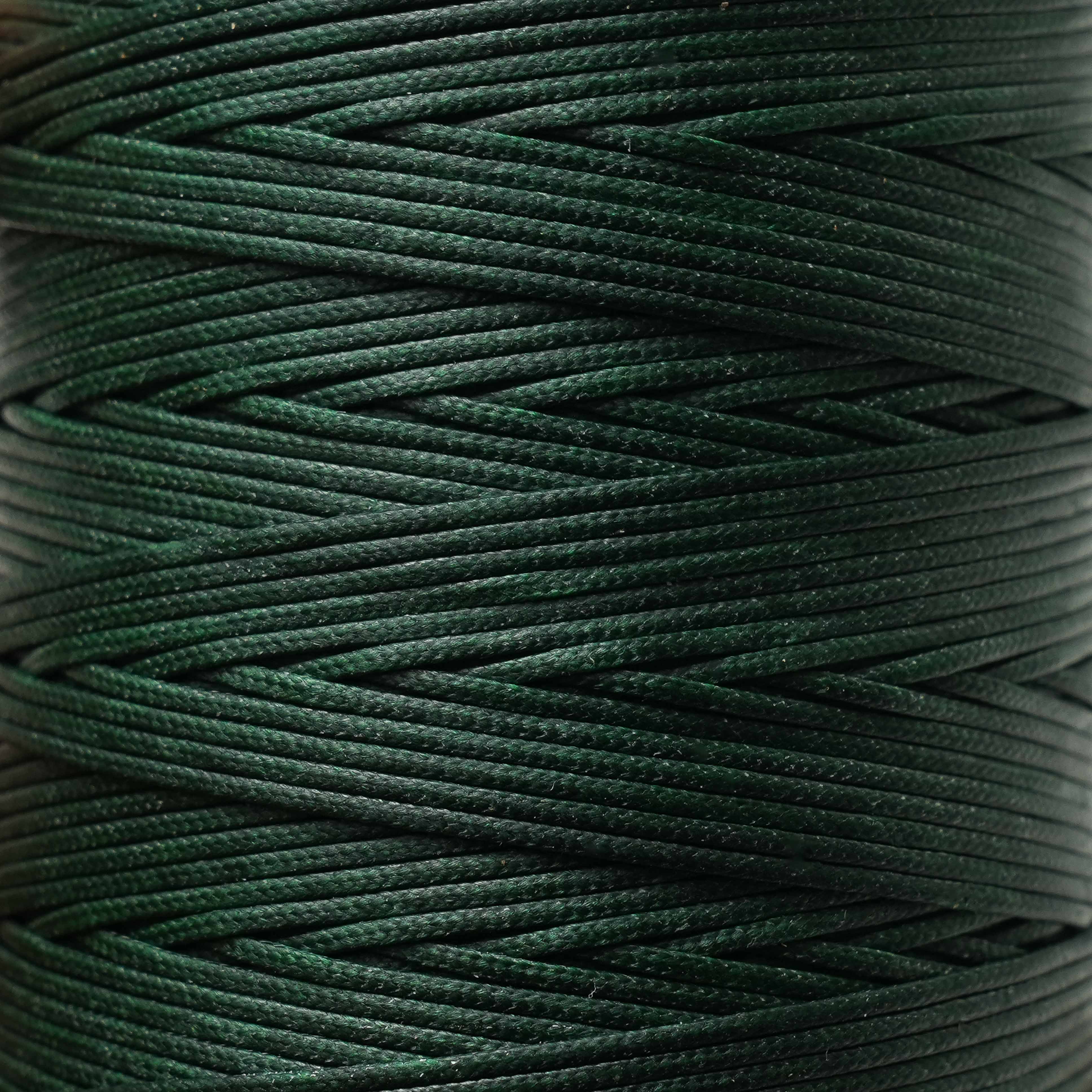 Close-up of a spool of spruce green thread